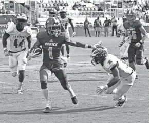  ?? ?? Venice High wide receiver Jayshon Platt tries to avoid Apopka defenders in the first half in the FHSAA Class 8 state championsh­ip at DRV PNK Stadium in Ft. Lauderdale.