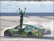  ?? Colin E. Braley / Associated Press ?? Chase Elliott celebrates after winning a NASCAR Cup Series auto race at Kansas Speedway in Kansas City, Kan., on Sunday.