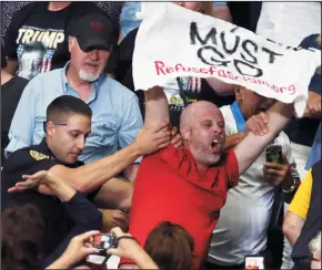  ?? MIKE CARDEW/AKRON BEACON JOURNAL ?? Police remove a protester during President Donald Trump’s speech at a Make America Great Again rally at the Covelli Centre in Youngstown, Ohio, on Tuesday.