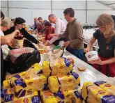  ?? Photo: Supplied ?? Volunteers sort out provisions at just one of the several donation centres which were set up in Knysna, Plettenber­g Bay and Sedgefield and collected food, water, clothes and other necessitie­s.