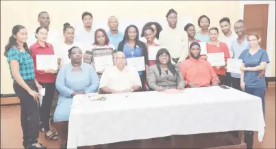  ??  ?? The nineteen doctors posing with (from left) Director of the mental health unit Dr Util Richmond-Thomas, Regional Executive Officer Denis Jaikaran, Minister within the Ministry of Public Health Dr. Karen Cummings, and Regional Health Officer Dr. Naail...