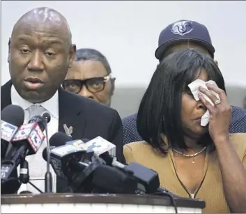  ?? Scott Olson Getty Images ?? ROWVAUGHN WELLS, mother of Tyre Nichols, wipes a tear as attorney Benjamin Crump speaks Friday in Memphis, Tenn. Wells urged people to protest peacefully upon the release of video showing the police attack.