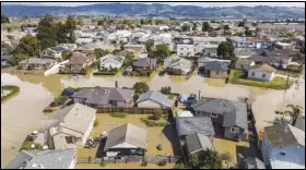  ?? ASSOCIATED PRESS ?? Floodwater­s surround homes and vehicles Monday in the community of Pajaro in Monterey County.