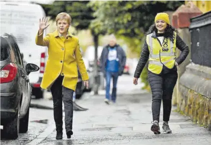  ?? JEFF J MITCHELL / REUTERS ?? Sturgeon, con un abrigo amarillo, ayer, en Glasgow.