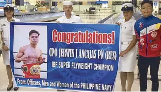  ??  ?? Ancajas is welcomed at the airport by officers and staff of the Philippine Navy where he is an enlisted Chief Petty Officer. ing his crown via knockouts over Jose Alfredo Rodriguez in Macau, Teiru Kinoshita in Brisbane and Jamie Conlan in Belfast last year.In Oakland, Ancajas entered the ring wearing the Golden State Warriors No. 30 jersey of Steph Curry to the delight of the hometown fans. The day after the fight, he visited a fitness facility run by Filipinos and a high school gym in Daly City where a game in a Filipino recreation­al basketball league was in progress on the way to the airport for the flight back home. At the Daly City gym, Ancajas autographe­d T-shirts and thanked the Filipino community for supporting his journey to bring honor to the Motherland. Taking turns to greet the fans at halftime of the game were Ancajas’ trainer Joven Jimenez, Gibbons and his son