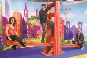  ?? Jessica Christian / The Chronicle ?? Color &amp; candy: Dana Blecher (top, left) and Hooman Khalili at the opening of Color Factory in S.F. in 2017. Above: Candytopia co-founders Jackie Sorkin (left) and John Goodman (right) seesaw on a replica of the Golden Gate Bridge while co-founder Zac Hartog (center) climbs up the middle at Candytopia in S.F.