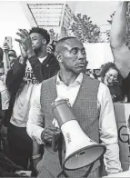  ??  ?? Minneapoli­s native P.J. Hill, a former Ohio State basketball player, speaks at a protest in Minneapoli­s after the murder of George Floyd during the summer of 2020.