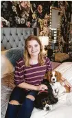  ?? Melissa Phillip / Staff photograph­er ?? Brooke Kotrla and her dogs in her room designed by Richardson, who works through Texas Children’s Hospital.