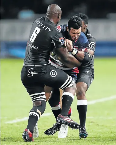  ?? Picture: AFP ?? NOWHERE TO GO: The Sharks’ Lubabalo Mtembu, 6, tackles the Rebels’ Jack Debreczeni during their Super Rugby match at Kings Park Stadium in Durban last night