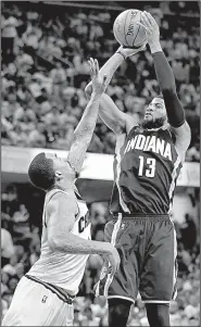  ?? AP/TONY DEJAK ?? Indiana forward Paul George (13) shoots over Cleveland’s J.R. Smith in the second half of the Cavaliers’ 109-108 victory in the first game of their NBA Eastern Conference series against the Pacers. George had a team-high 29 points for the Pacers.