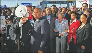  ?? (File Photo/AP/Kevin Glackmeye) ?? U.S. Rep. John Lewis, D-Ga., (center) talks in March 2012 with those gathered on the historic Edmund Pettus Bridge during the 19th reenactmen­t of the “Bloody Sunday” Selma to Montgomery civil rights march across the bridge in Selma, Ala.