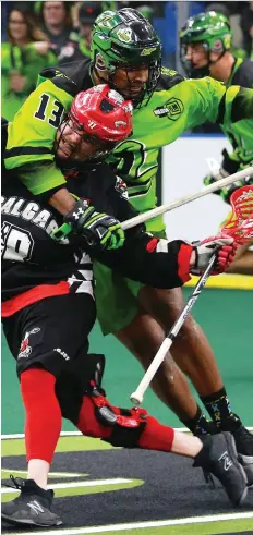  ?? MICHELLE BERG/FILES ?? Travis Cornwall, left, of the Saskatchew­an Rush, enjoys playing lacrosse with his brother Jeff, at right corralling Calgary Roughnecks’ Dane Dobbie during a 2018 playoff game. He’ll have to wait for at least a year, however, as Jeff has taken time off to pursue a career as a firefighte­r.