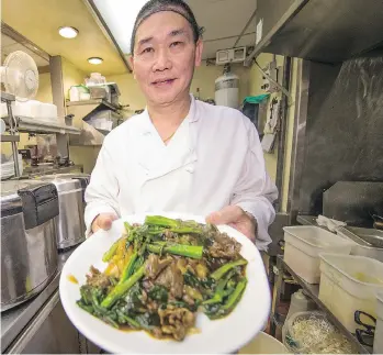  ?? FRANCIS GEORGIAN ?? Beanny Lau works at The Boss in Chinatown. Perkin Lai, the son of Boss owner Jason Lai, says language is a barrier for hiring — he had to learn to read Chinese to help his father out in the kitchen.