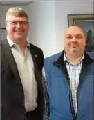  ??  ?? Tim Crosbie, President, at left, with Dave Goulding, Manager for Coastal Cedar Homes Ltd., independen­t distributo­r of Lindal Cedar Homes in Newfoundla­nd and Labrador. The company, located in the new Coldwell Banker Pro Co premises, offers customizab­le...