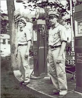  ?? PHOTOGRAPH FROM THE COLLECTION OF THE GUNN HISTORICAL MUSEUM ?? Stanley and Elmer Gunnarson stand at the gas pumps in front of Gunnarson’s Garage on School Street in Washington Depot, circa 1932.