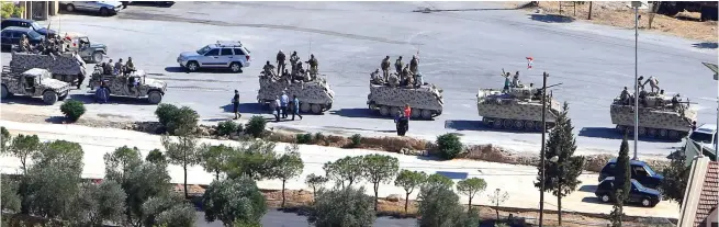  ??  ?? Lebanese soldiers in military tanks in the town of Ras Baalbek on Saturday. (Reuters)