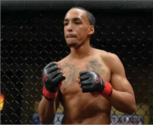  ?? Photo by Will Paul / CES ?? Woonsocket flyweight Jose Lugo improved to 3-0 after using a rear-naked choke to defeat Michael Taylor in the second round of their 130-pound bout at CES MMA 50 Friday at Twin River.