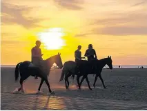  ??  ?? From left: Horse riding on the beach at sunset; Trouville’s historic fish market; a quiet moment on Deauville’s waters, and the seaside resort’s gambling halls which inspired the first James Bond novel, Casino Royale