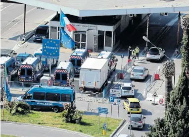  ?? Picture: VALERY HACHE/AFP ?? MILLIONS QUARANTINE­D: Police control motorists at the French-Italian border checkpoint in Mento yesterday as the Italian government takes urgent steps to try stop the spread of the deadly coronaviru­s