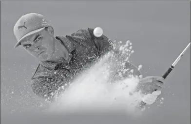  ?? Associated Press ?? Bunker shot: Rickie Fowler hits from the bunker on the 16th hole during the first round of the PGA Championsh­ip golf tournament at the Quail Hollow Club Thursday in Charlotte, N.C.