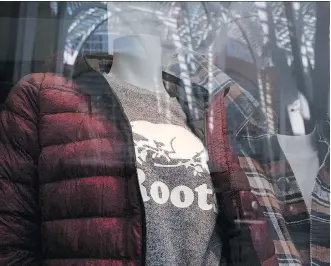  ?? THE CANADIAN PRESS/CHRIS YOUNG ?? A mannequin displaying a Roots-branded shirt stands in the storefront window of a Roots location in Toronto. One of Canada’s best-known clothing retailers, Roots Corp., announced on Wednesday its plans to launch an initial public offering of its shares.