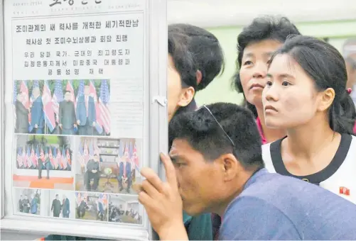  ?? Photos / AP ?? North Koreans were able to read about the summit in yesterday’s edition of the Rodong Sinmun.