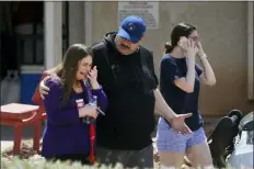  ?? BRIANA SANCHEZ/THE EL PASO TIMES VIA AP ?? People arrive at MacArthur Elementary looking for family and friends as the school is being used a re-unificatio­n center during the aftermath of a shooting at the Walmart near the Cielo Vista Mall, Saturday, in El Paso, Texas. Multiple people were killed and one person was in custody after a shooter went on a rampage at a shopping mall, police in the Texas border town of El Paso said.