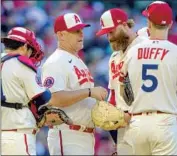  ?? Alex Gallardo Associated Press ?? ANGELS INTERIM manager Phil Nevin, second from left, talks with relief pitcher Archie Bradley.