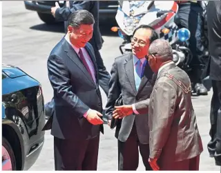  ??  ?? Forging new ties: Xi being greeted by Papau New Guinea’s Governor General Bob Dadae after a welcoming ceremony at Parliament House in Port Moresby ahead of the Apec Summit. — AFP