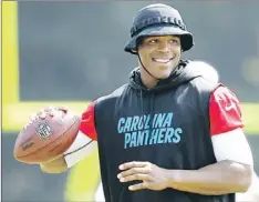  ?? — Photo by The Associated Press ?? Carolina Panthers’ quarterbac­k Cam Newton sports some extra protection from the sun during a practice at the NFL team’s training camp in Spartanbur­g, S.C., on Monday.