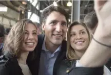  ?? ANDREW VAUGHAN/THE CANADIAN PRESS ?? Prime Minister Justin Trudeau poses for a photo as he visits the Seaport Farmers’ Market in Halifax on Saturday.