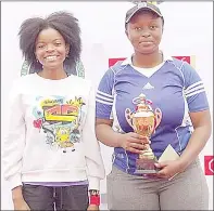  ?? ?? Back-to-back champion Tandzile Dlamini (R) holding the trophy while joined by runner-up Temancele Mavuso.