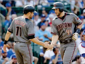  ?? ASSOCIATED PRESS ?? ARIZONA DIAMONDBAC­KS’ PAUL GOLDSCHMID­T (RIGHT) celebrates with A.J. Pollock after hitting a two-run home run during the fifth inning against the Chicago Cubs on Thursday in Chicago.