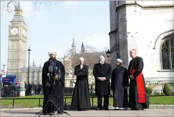  ?? — Reuters photo ?? Inter-faith leaders hold a vigil outside Westminste­r Abbey following a recent attack in Westminste­r, London.