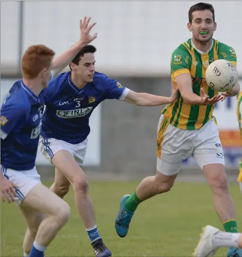  ??  ?? Billy Smith passes to Robbie Curran as St Mary’s defenders close in, during their Division 1 clash on Friday night. Pictures: Ken Finegan