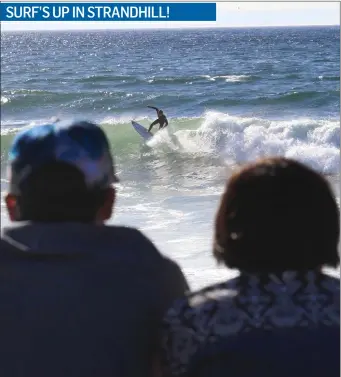  ??  ?? Surf’s Up at the Clean Coast Beach Rescue ProJect in Strandhill last Saturday. Onlookers enjoy watching a surfer in action. Pic: Carl Brennan.