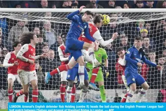  ?? — AFP ?? LONDON: Arsenal’s English defender Rob Holding (centre R) heads the ball during the English Premier League football match between Chelsea and Arsenal at Stamford Bridge in London.