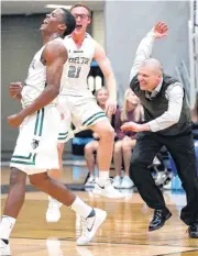  ?? [PHOTO BY SARAH PHIPPS, THE OKLAHOMAN] ?? Norman North’s Jalen Crutchfiel­d, left, and Colton Castleberr­y celebrates with coach Bryan Merritt their regional championsh­ip win over Edmond Memorial.