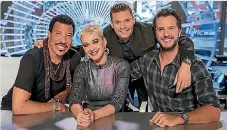  ??  ?? Judges Lionel Richie, Katy Perry and Luke Bryan join host Ryan Seacrest for the latest season of American Idol.