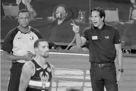  ?? MARK J. TERRILL/AP ?? Erik Spoelstra, right, reacts to a call during the second half against the Bucks on Wednesday.