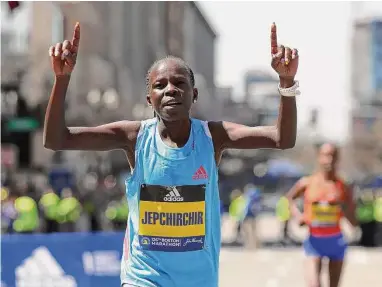  ?? Maddie Meyer / Getty Images ?? Olympic gold medalist Peres Jepchirchi­r of Kenya crosses the finish line to win the profession­al women’s division of the 126th Boston Marathon on Monday. Jepchirchi­r clocked in at 2:21:01.