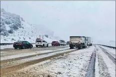  ?? Caltrans By Soumya Karlamangl­a and Jaclyn Cosgrove ?? TRAFFIC is stopped Monday along Interstate 5, where it has been closed because of snow at the Tejon Pass, also known as the Grapevine.