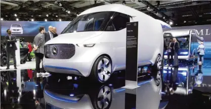  ??  ?? BERLIN: Participan­ts of the Daimler general meeting look at a Mercedes-Benz Vision Van on display in the CityCube exhibition in Berlin, Germany, yesterday. — AP