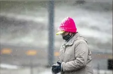  ?? Alexandra Wimley/Post-Gazette ?? Snow accumulate­s on the hat of a person walking along Lake Shore Drive in North Park on Jan. 16.