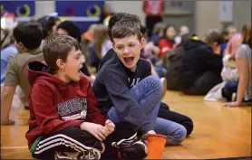  ?? NWA Democrat-Gazette/BEN GOFF • @NWABENGOFF ?? Caleb Cessario (left) and fifth-grade classmate Easton Lyle react to a speaker Monday during an assembly at Old High Middle School in Bentonvill­e. The event was a celebratio­n of the school being designated a Diamond School to Watch by the Arkansas...