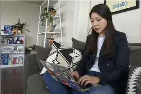  ?? AP PHOTO/NOREEN NASIR ?? Grace Pai, director of organizing at Chicago’s Asian Americans Advancing Justice branch, works on her computer in her apartment March 18, in Chicago.