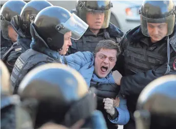  ?? MAXIM SHIPENKOV, EUROPEAN PRESSPHOTO AGENCY ?? Russian riot policemen detain a demonstrat­or in an opposition rally Sunday in central Moscow.