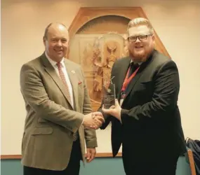  ??  ?? Andrew Hunter of Merchiston, receives the best-schools.co.uk crystal award for top Scottish boarding school from Ryan Crittenden of Education Advisers