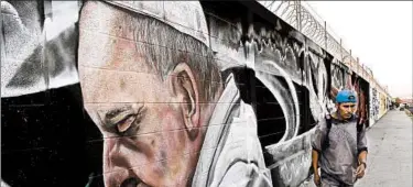  ?? JOSE MENDEZ/EPA ?? A mural honoring Pope Francis adorns a wall in Ecatepec, Mexico, ahead of his trip to the country, which starts this week.