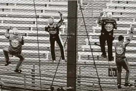  ??  ?? Harvick, second from left, along with Chase Briscoe’s win in the Xfinity Series, earned a sweep for Stewart-Haas Racing for the weekend.